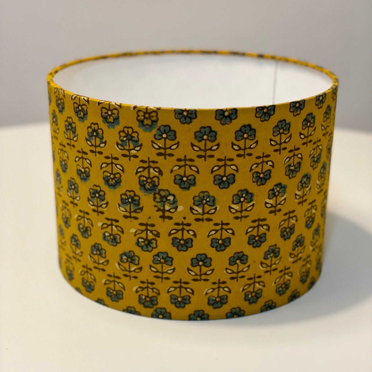 10 inch Drum Lampshade. Turmeric Dyed Ajrak Hand Block Print. Turmeric with Greyish-Blue and Dark Grey Floral Motif.