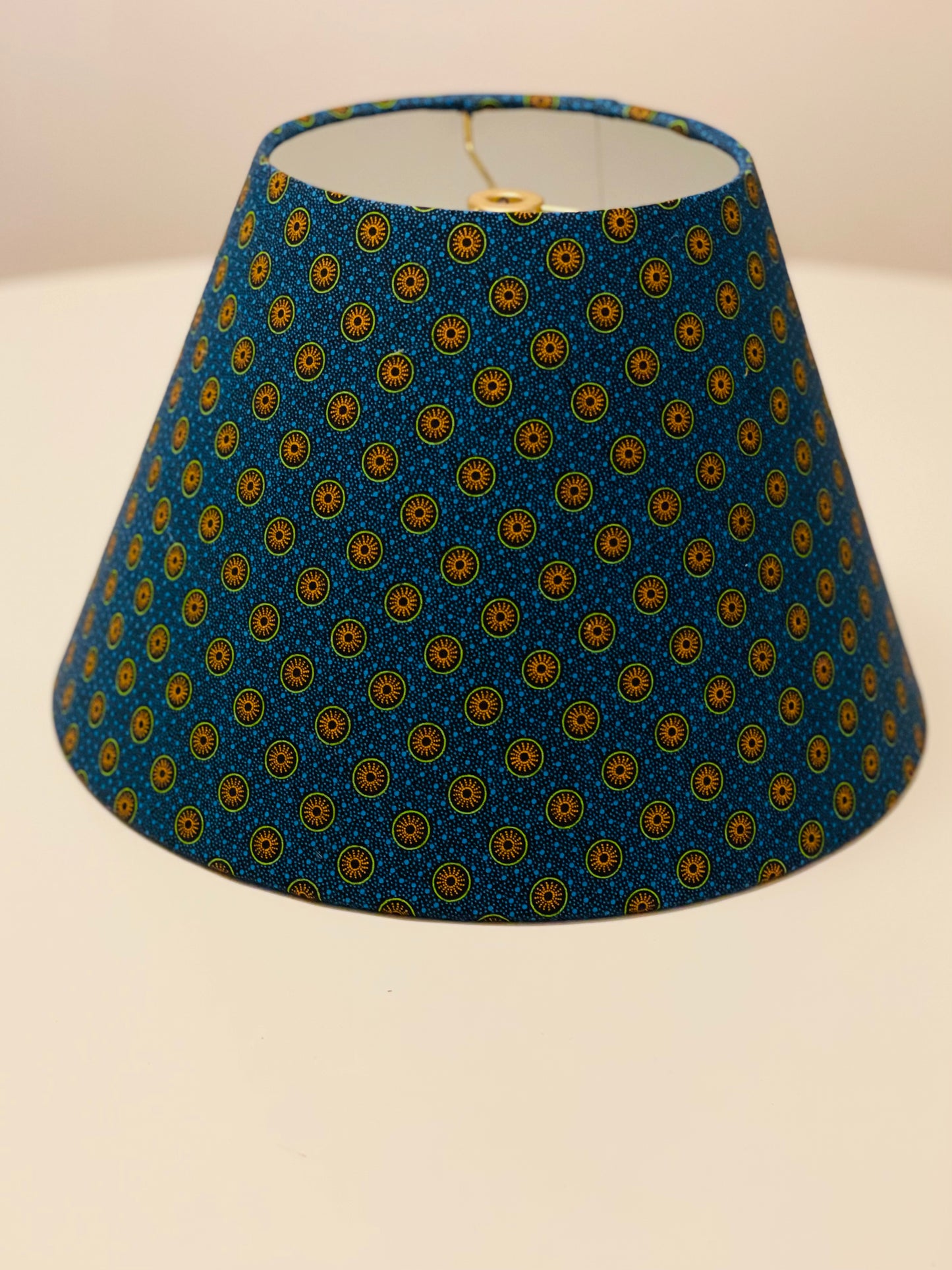 Small Conical Lampshade. Dynamic South African Shwe Shwe Print- Navy Blue with Orange and Green Medallion and Tiny Blue Dots.