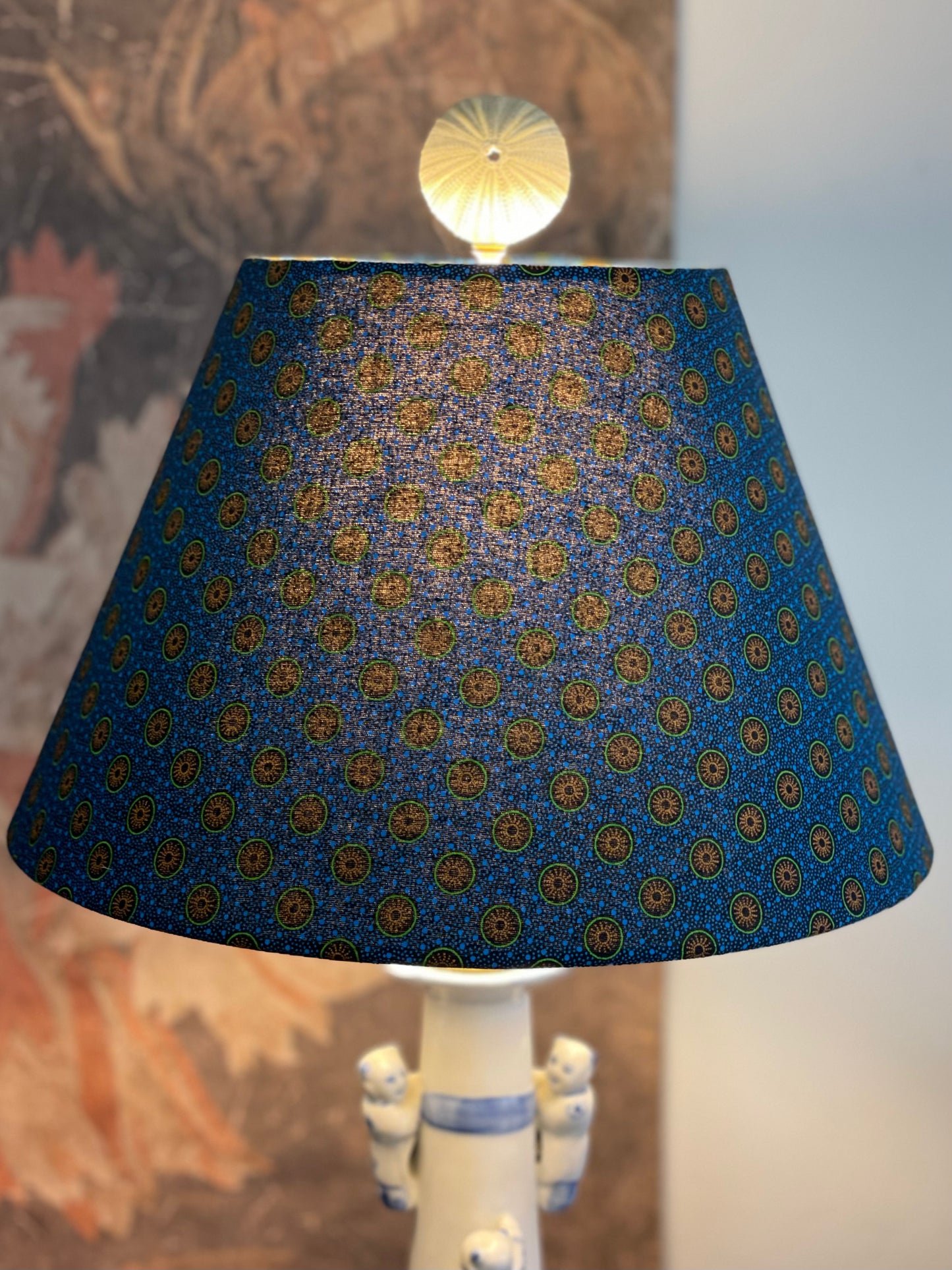 Small Conical Lampshade. Dynamic South African Shwe Shwe Print- Navy Blue with Orange and Green Medallion and Tiny Blue Dots.