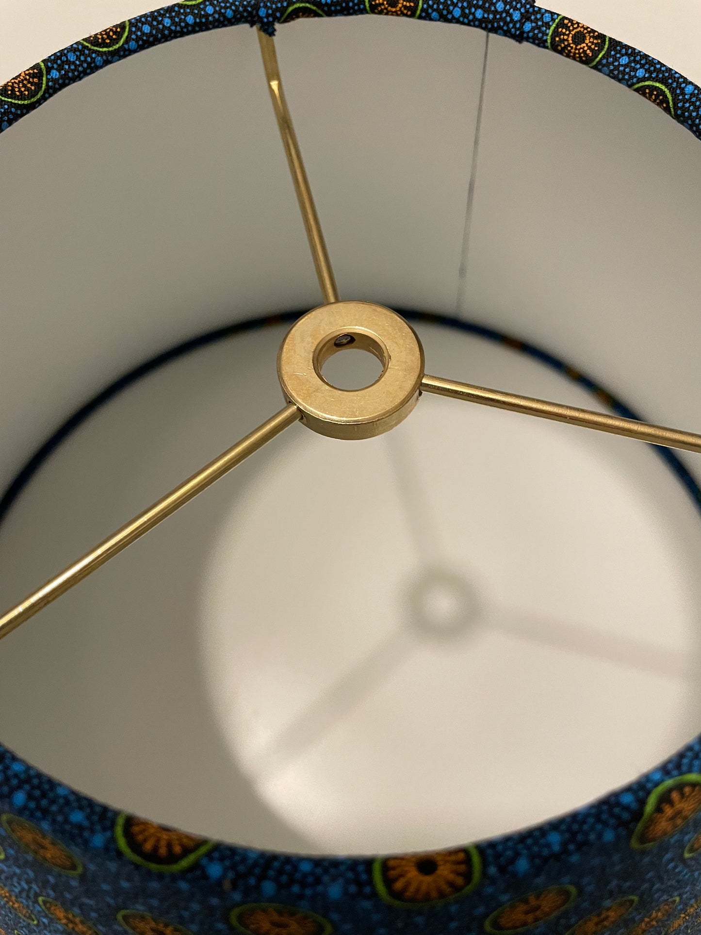 Small Conical Lampshade. Dynamic South African Shwe Shwe Print- Navy Blue with Orange and Green Medallion and Tiny Blue Dots.