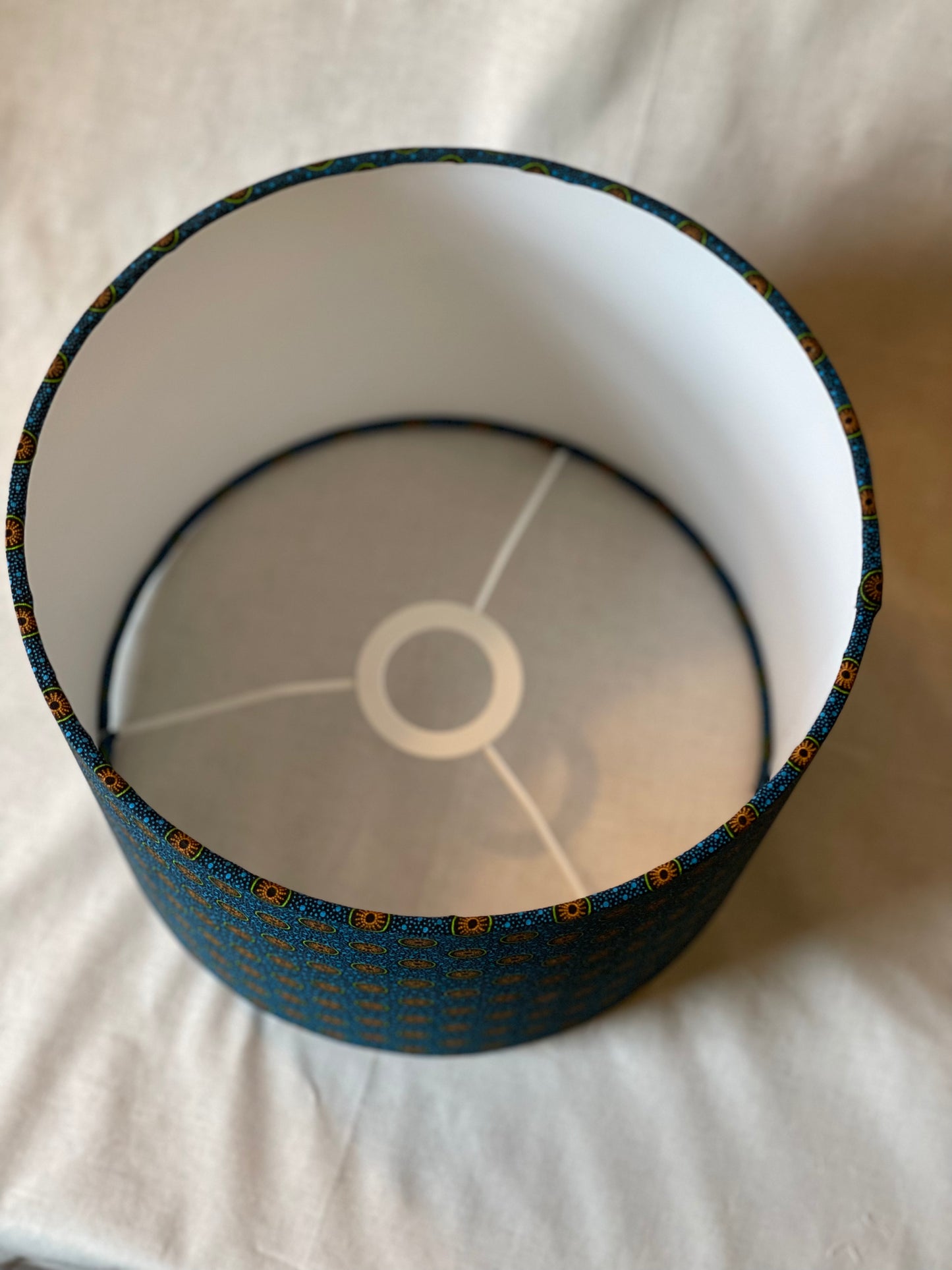 10 inch Drum Lampshade. Dynamic South African Shwe Shwe Print- Navy Blue with Orange and Green Medallion and Tiny Blue Dots.