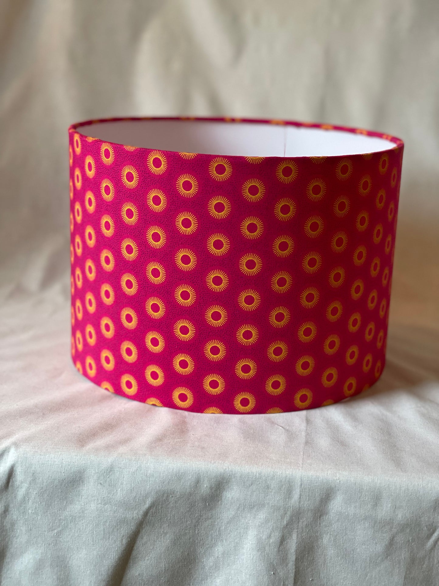 10 inch Drum Lampshade. Dynamic South African Shwe Shwe Print- Hot Pink with Golden Yellow Sun Motif.