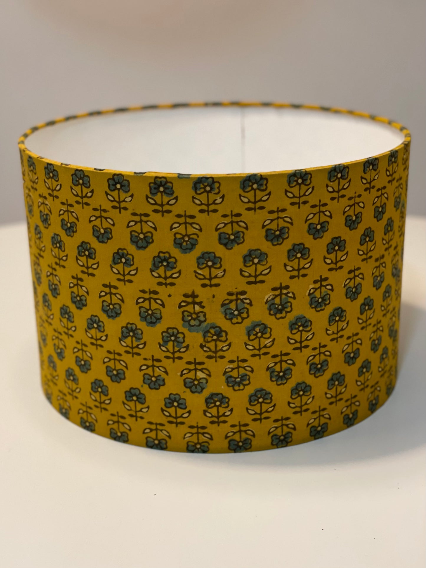 12 Inch Drum Lampshade. Turmeric Dyed Ajrak Hand Block Print. Turmeric with Greyish-Blue and Dark Grey Floral Motif.