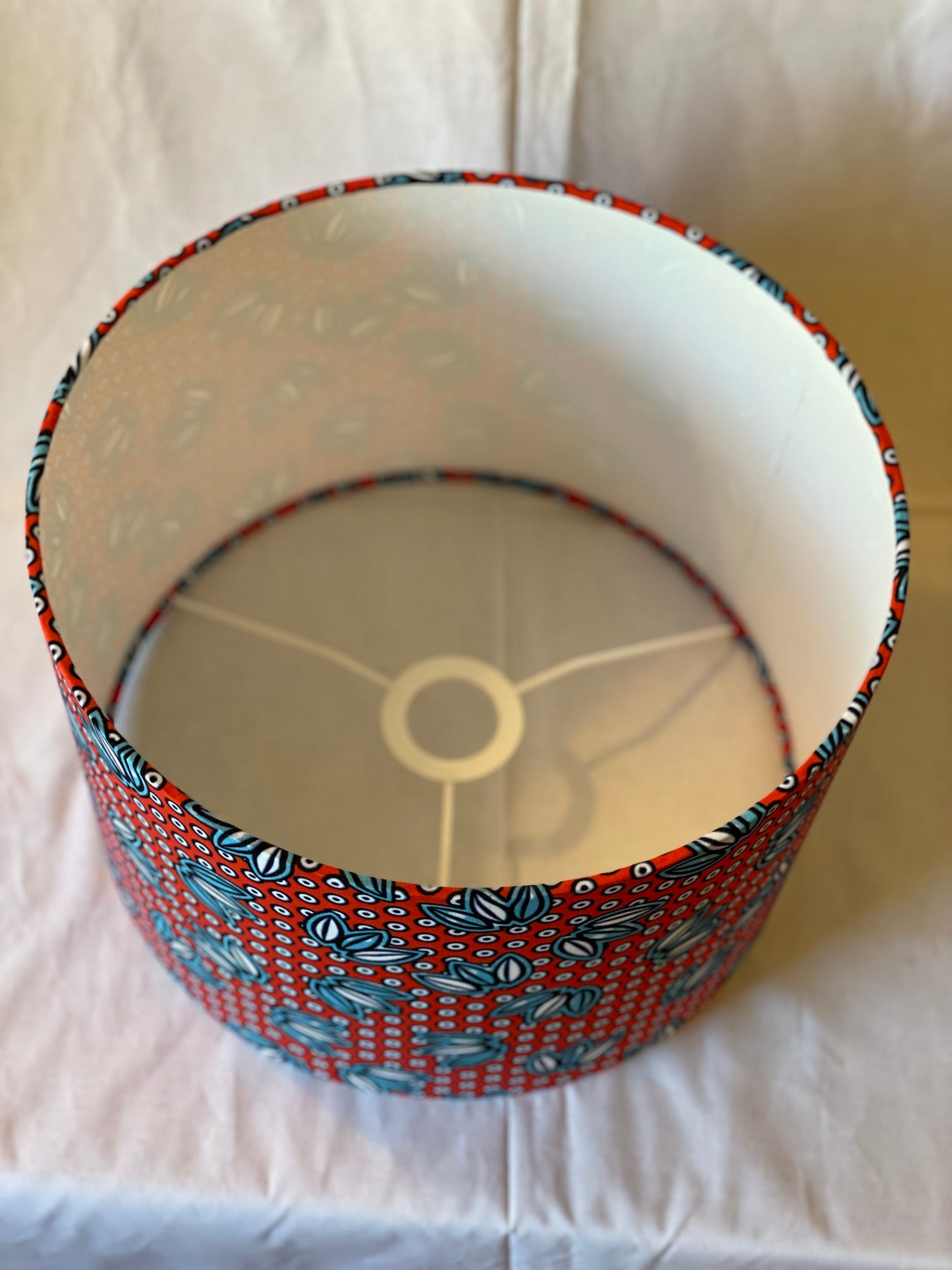 12 Inch Drum Shade. West African Ankara Fabric. Bright Red with Blue and White Floral and Circular Detail.